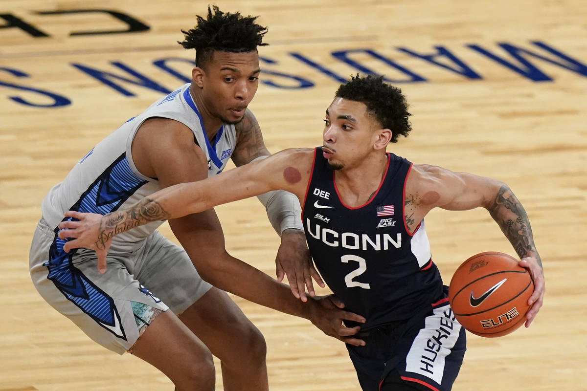 Connecticut's James Bouknight drives past Creighton's Antwann Jones during the first half of an ...