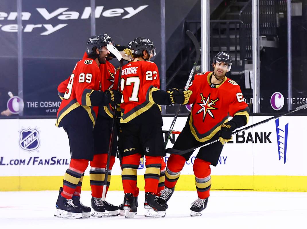 The Golden Knights celebrate after a goal by Max Pacioretty, right, during the first period of ...