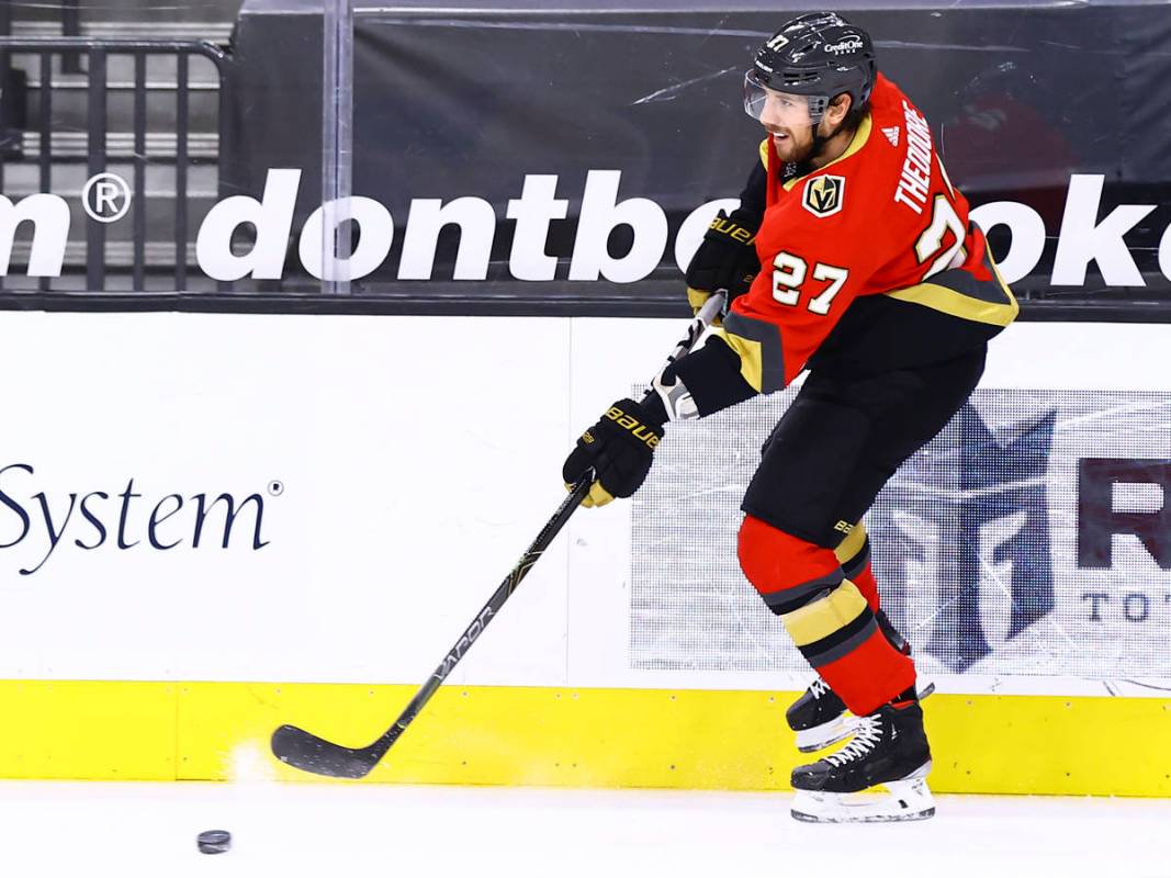 Golden Knights' Shea Theodore passes the puck during the first period of an NHL hockey game aga ...