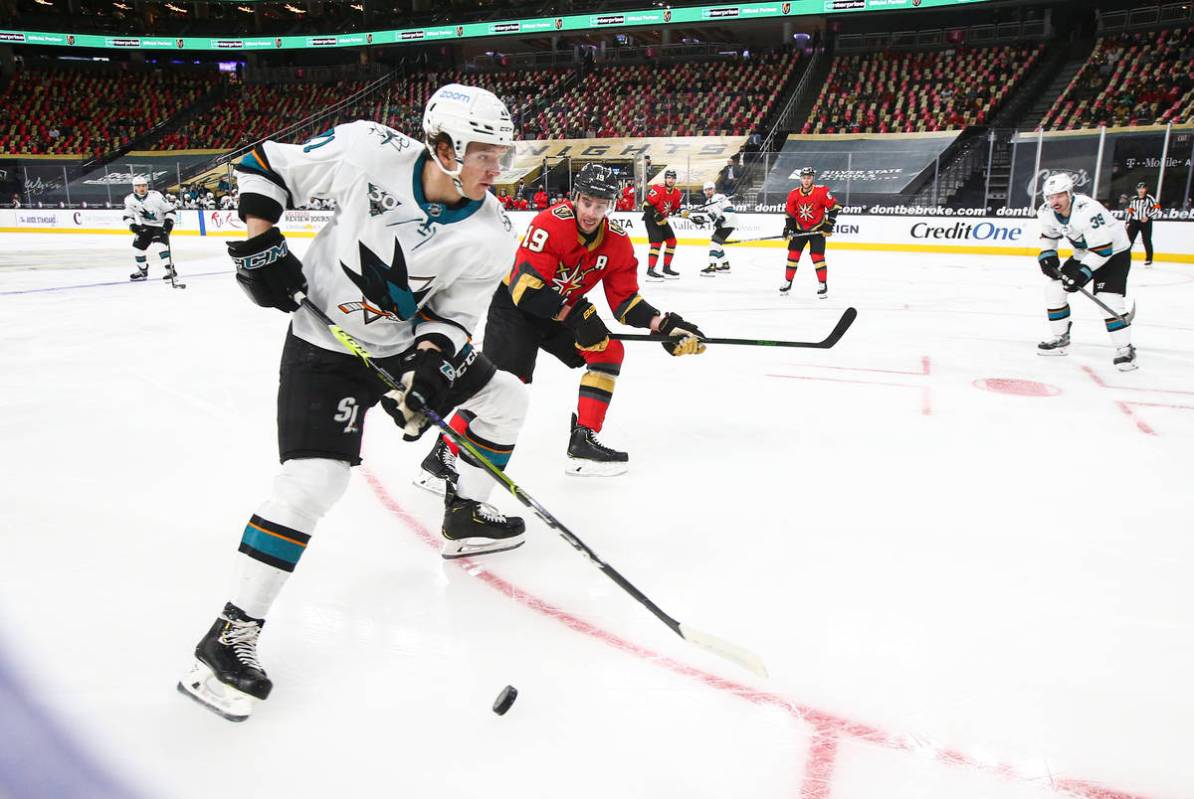 San Jose Sharks' Nikolai Knyzhov, left, skates with the puck against Golden Knights' Reilly Smi ...