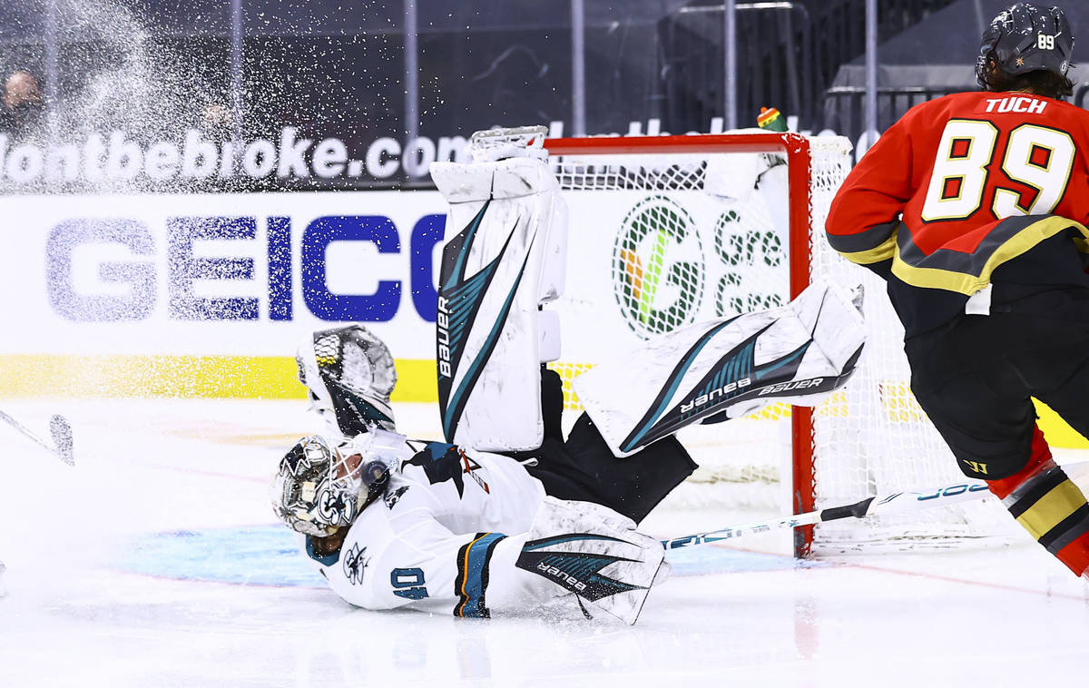 San Jose Sharks goaltender Devan Dubnyk (40) stops the puck as it gets stuck in his throat prot ...