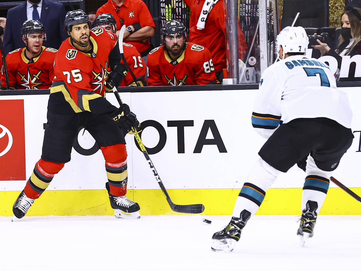 Golden Knights' Ryan Reaves (75) passes the puck in front of San Jose Sharks' Dylan Gambrell (7 ...