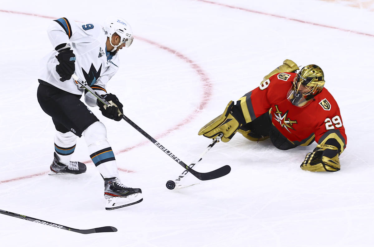 Golden Knights goaltender Marc-Andre Fleury (29) poke checks the puck away from San Jose Sharks ...