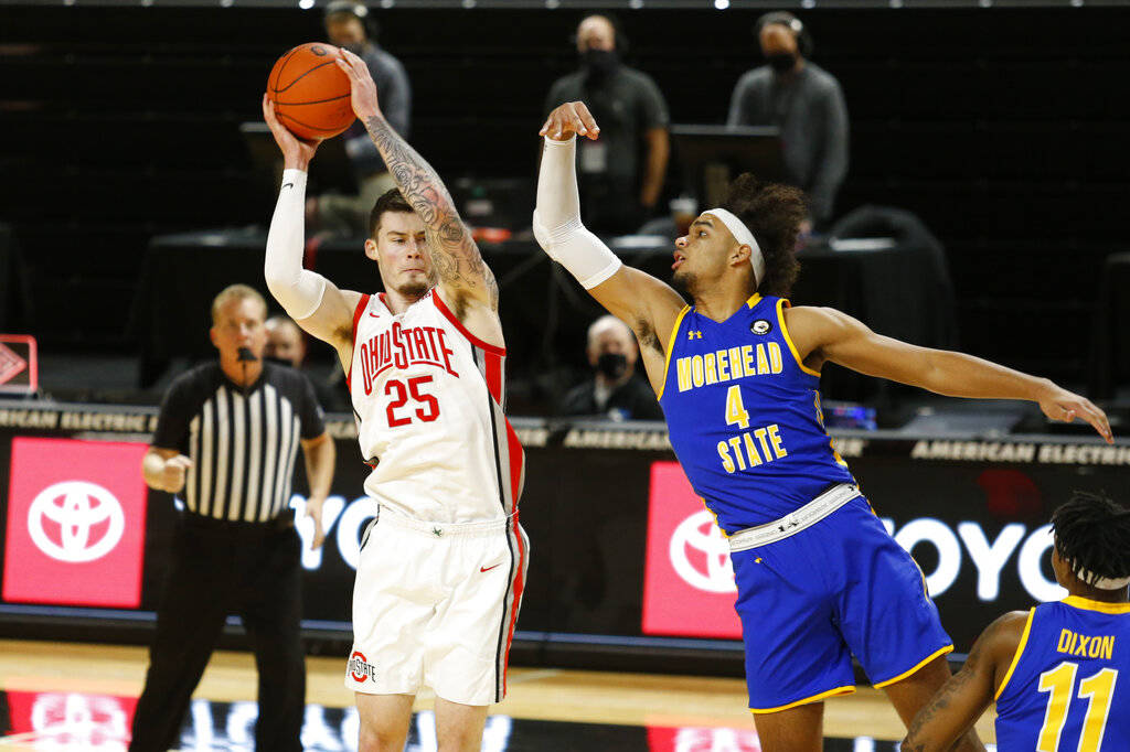 Ohio State forward Kyle Young, left, grabs a rebound against Morehead State forward Johni Broom ...