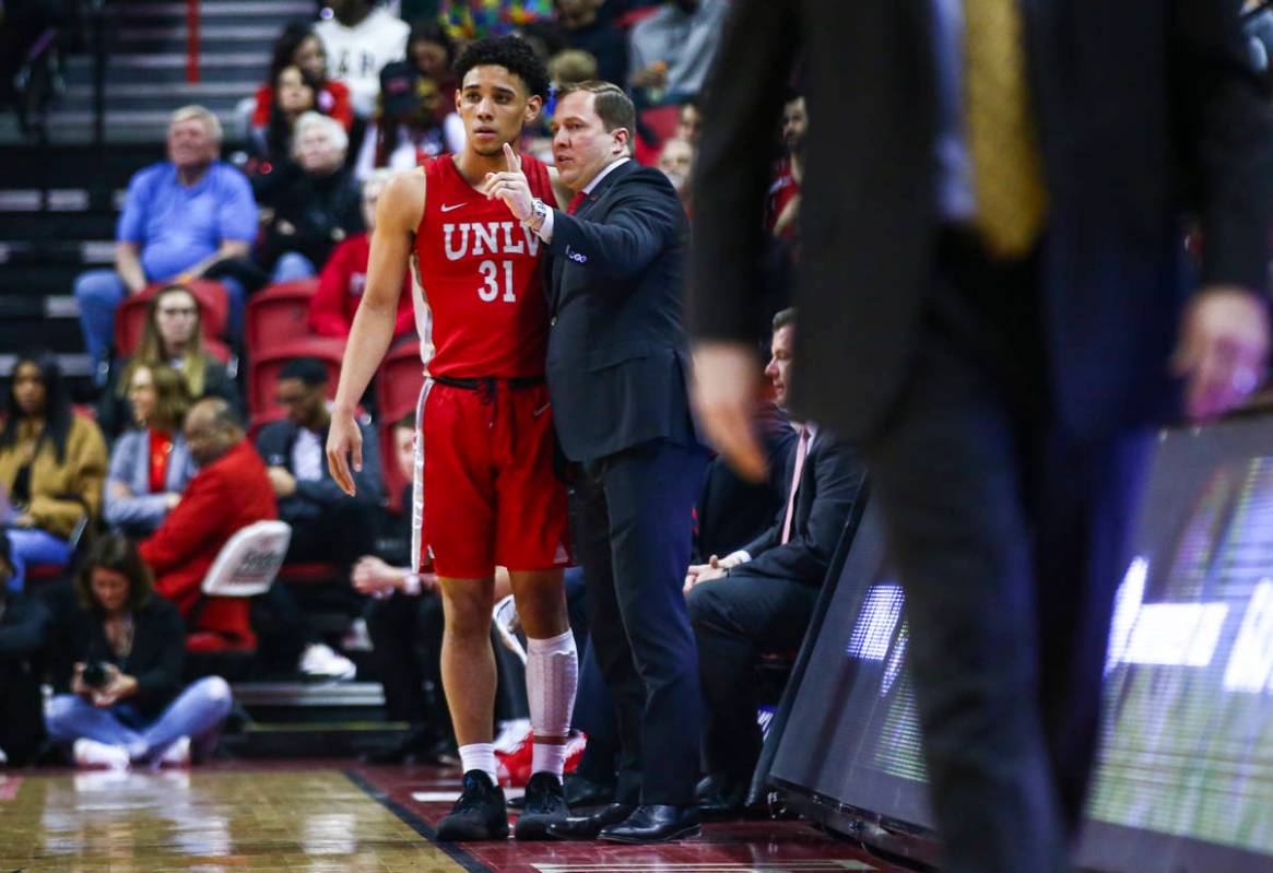 UNLV's Marvin Coleman (31) talks with UNLV's head coach T.J. Otzelberger during the first half ...