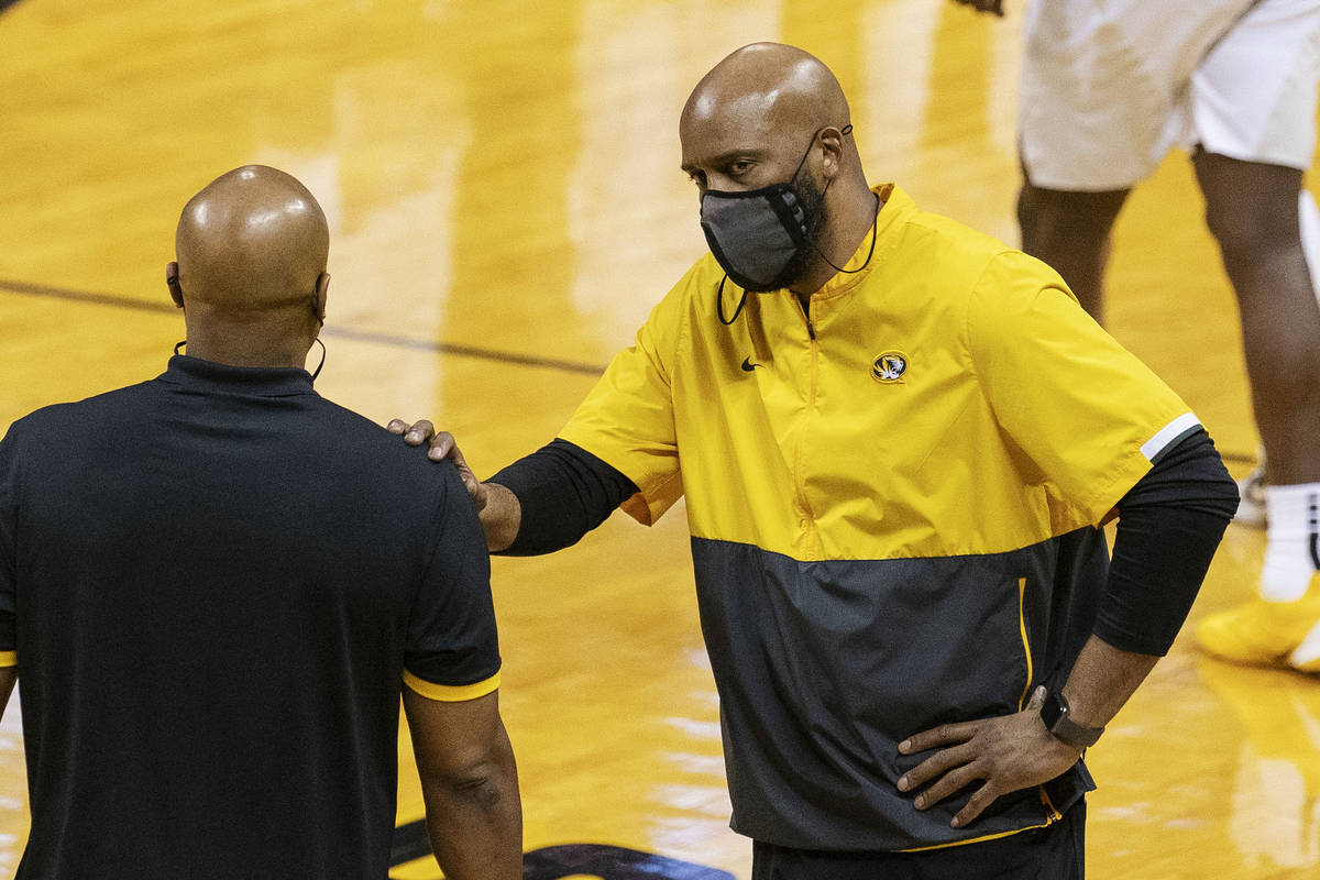 Missouri head coach Cuonzo Martin, right, steadies himself after a referee's call during the se ...