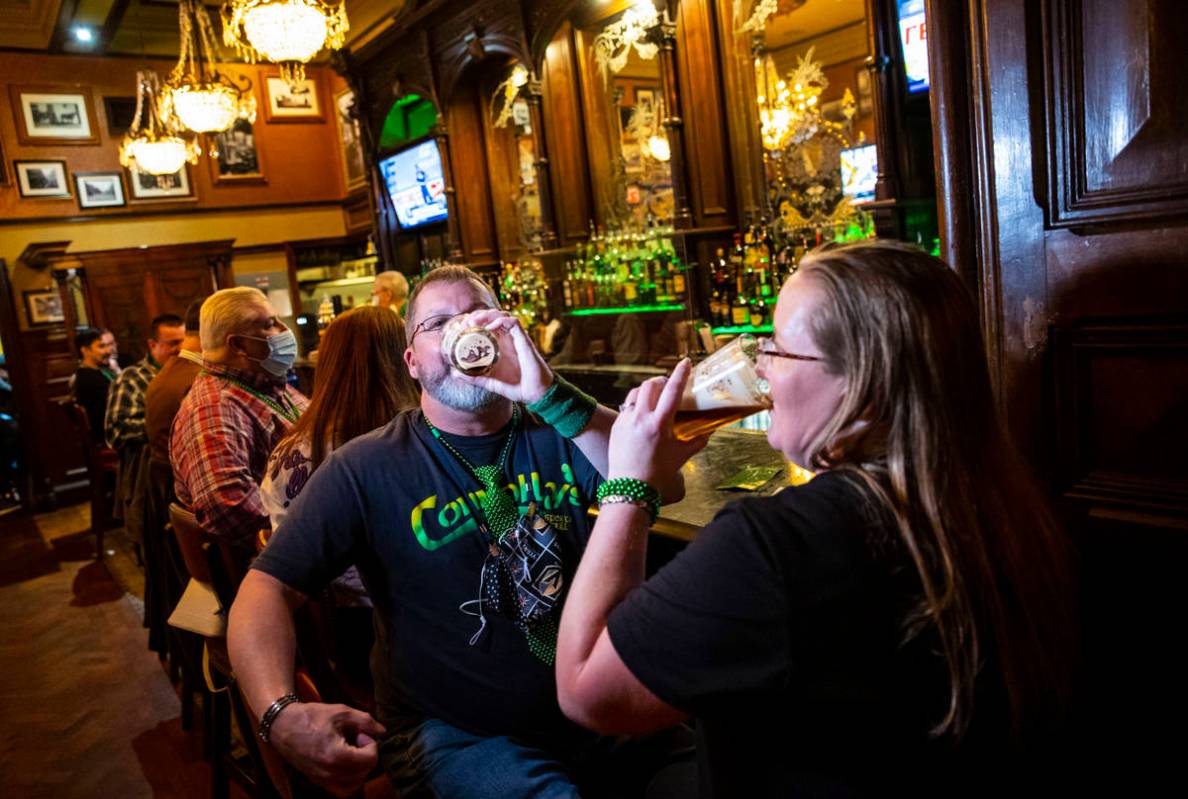 Paul Fink, left, and Regina Gordon, both of Phoenix, drink by the bar as people gather to celeb ...