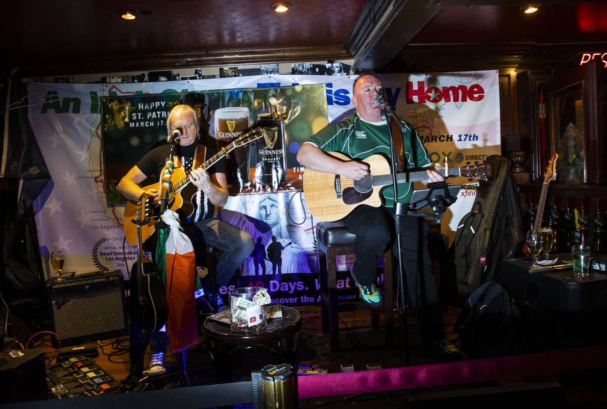 David Browne, left, and Dave Rooney, of The Black Donnellys, perform as people gather to celebr ...
