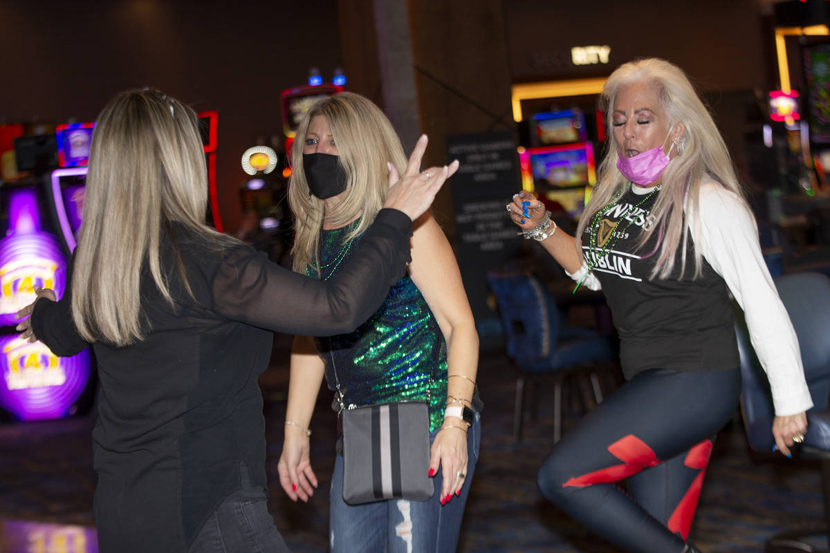 Christine Cowser, left, Debbie Andrews and Susie Swiercz dance to The Celtic Rockers play at RE ...