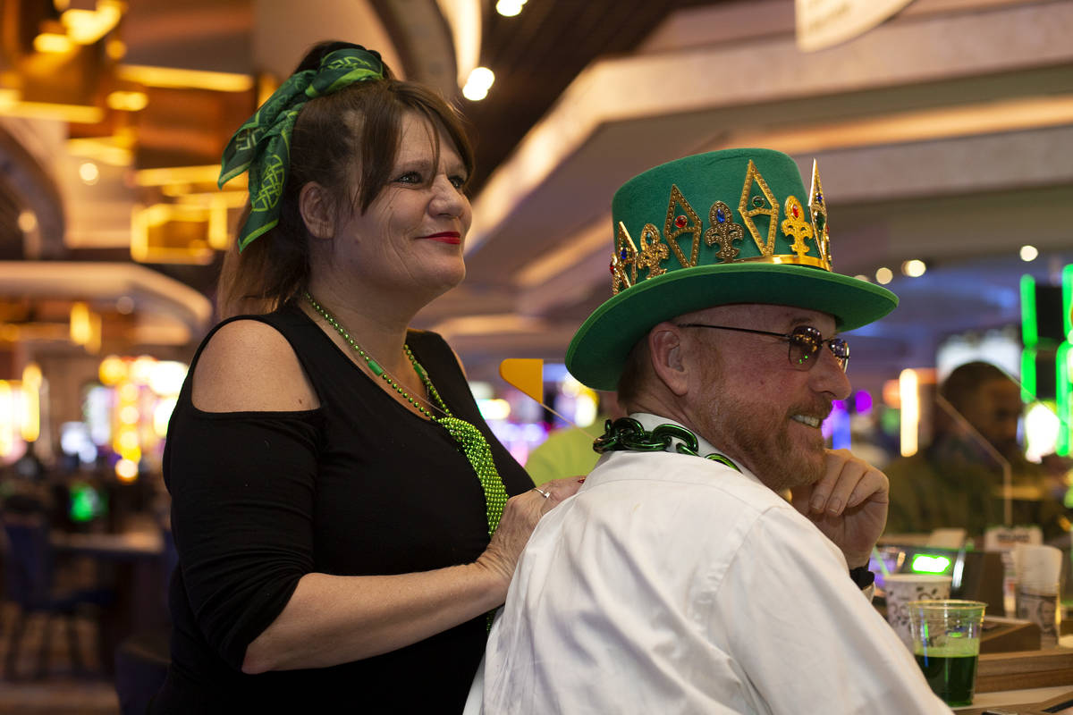 Christine O'Neil of Boston, left, and Jack Andrews of Baltimore listen to The Celtic Rockers pl ...