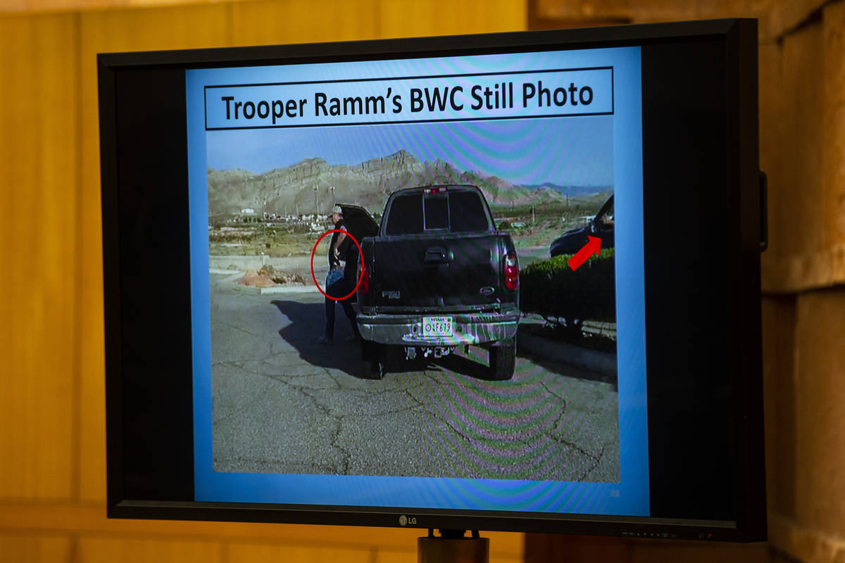A still image from body camera footage is shown during a fact-finding review for a fatal police ...