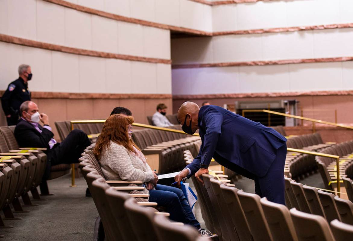 Defense attorney Carl Arnold, right, speaks to family members of James Pease, during a fact-fin ...