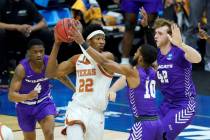 Texas' Kai Jones (22) is pressured by Abilene Christian defenders Damien Daniels (4), Reggie Mi ...