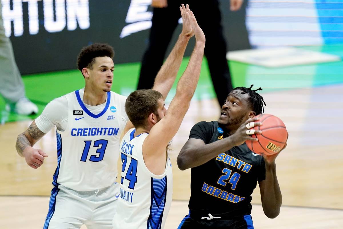 UC Santa Barbara's Robinson Idehen, right, is defended by Creighton's Mitch Ballock, center, an ...