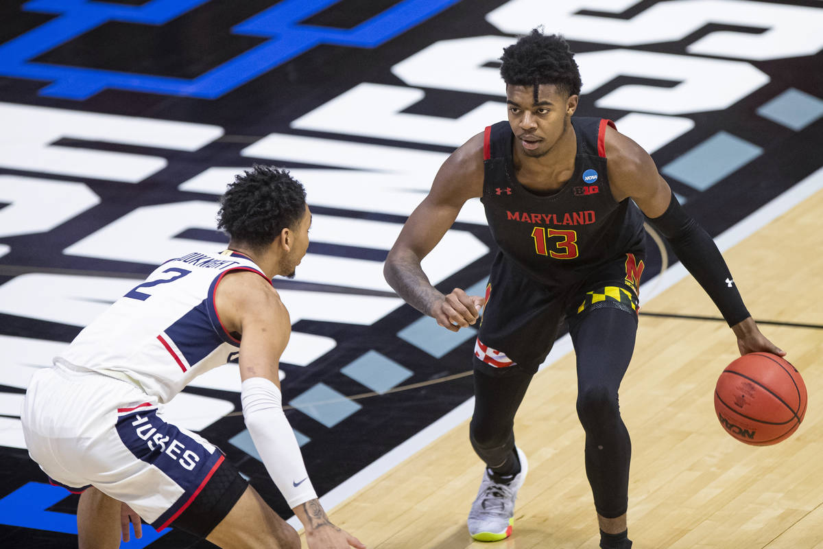 Maryland's Hakim Hart (13) is defended by Connecticut's James Bouknight (2) during the first ha ...