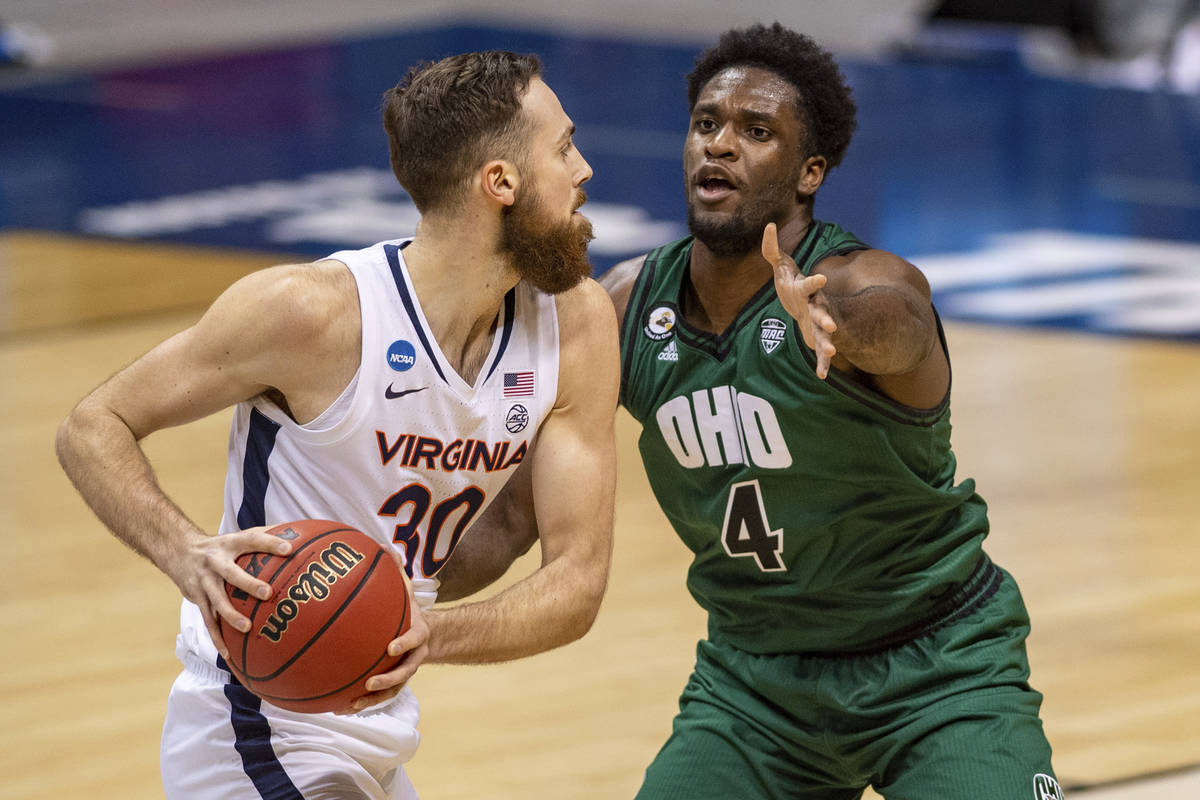 Ohio forward Dwight Wilson III (4) defends against Virginia forward Jay Huff (30) during the fi ...