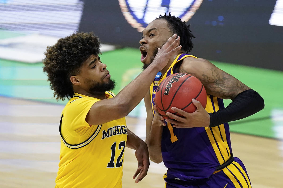 LSU guard Javonte Smart (1) drives to the basket past Michigan guard Mike Smith (12) during the ...