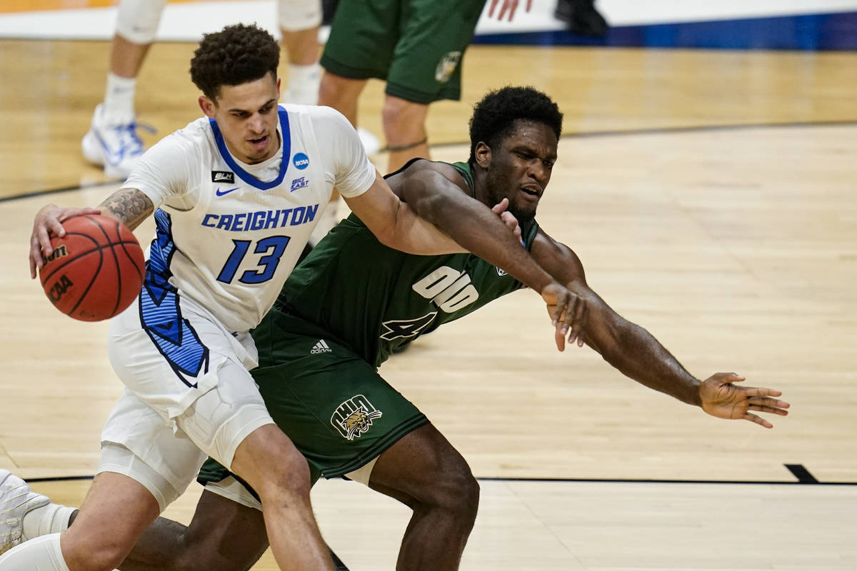 Creighton forward Christian Bishop (13) drives on Ohio forward Dwight Wilson III (4) in the fir ...