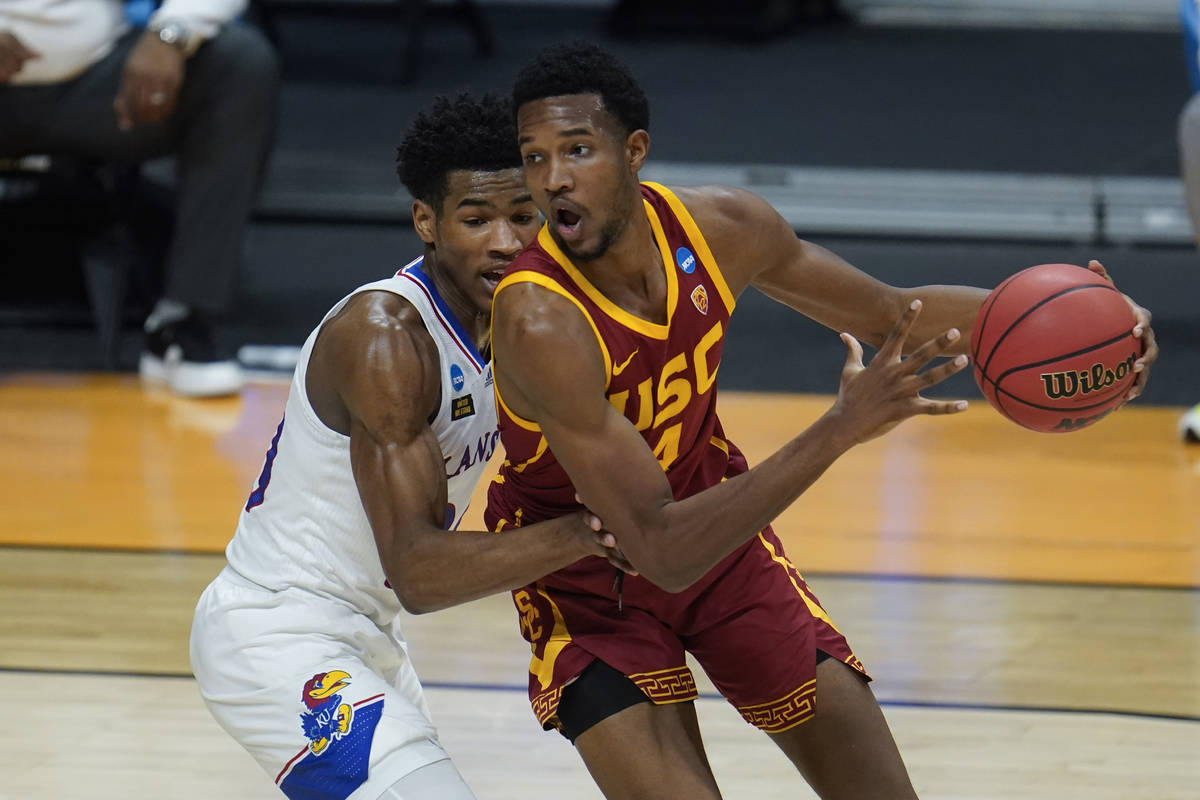 USC forward Evan Mobley (4) drives on Kansas guard Ochai Agbaji (30) during the first half of a ...