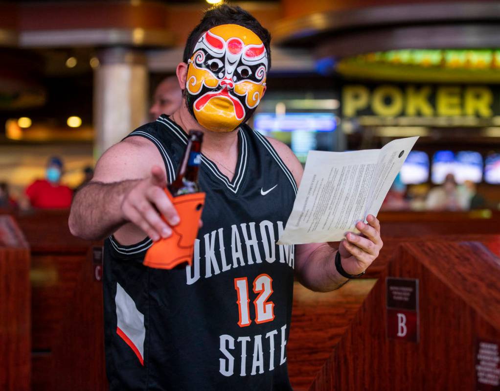 Kenny Bollwerk of Queens, N.Y., wears his team picking mask while taking in the action during o ...