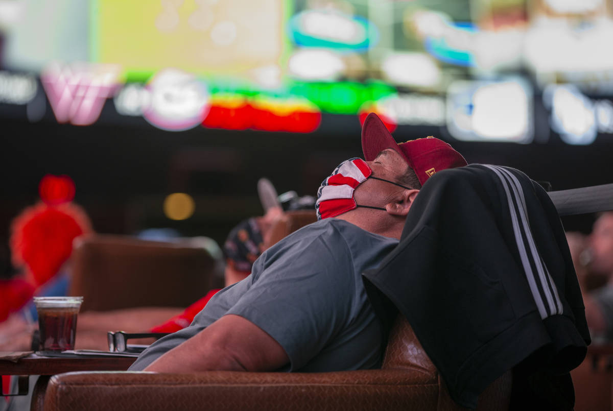 A bettor naps in the comfy chairs during opening day of NCAA Tournament play at the Westgate Su ...