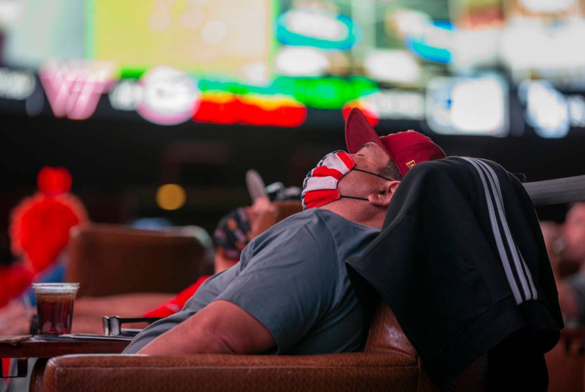 A bettor naps in the comfy chairs during opening day of NCAA Tournament play at the Westgate Su ...