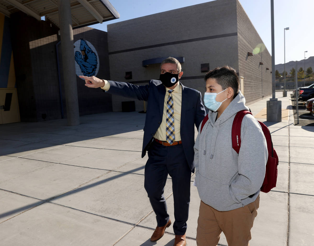 Principal Darryl Wyatt directs sixth grader Brandon Rivas-Garcia on the first day of in-person ...