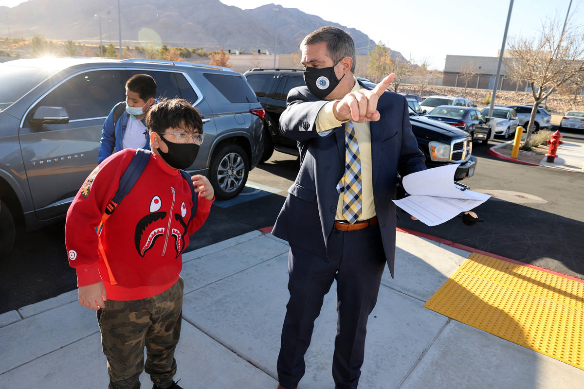 Principal Darryl Wyatt directs sixth grader Angel Resendiz-Martinez on the first day of in-pers ...