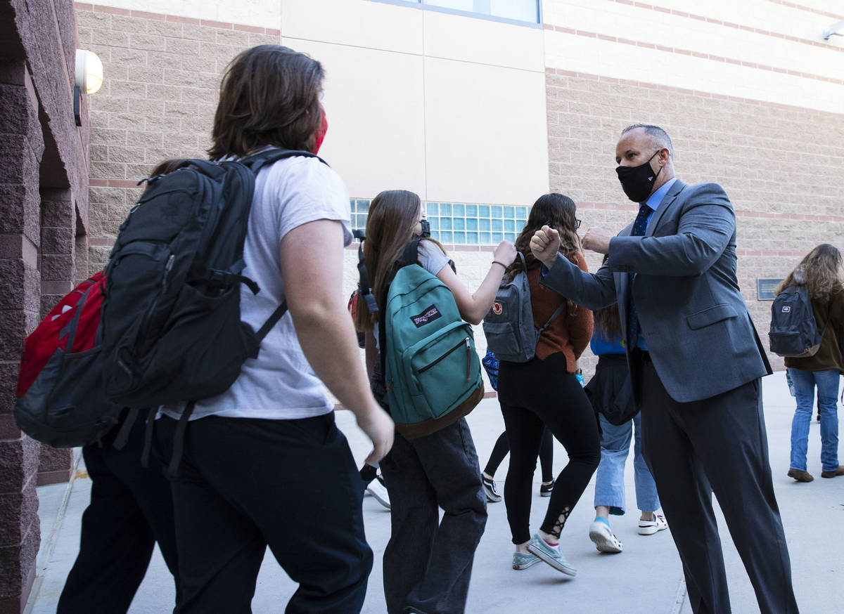 Liberty High School Principal, Derek Bellow, greets students, on Monday, March 22, 2021, in Hen ...