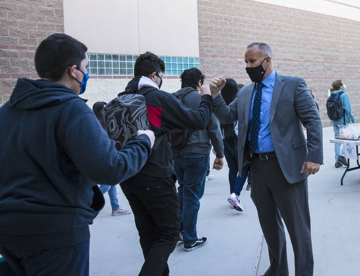 Liberty High School Principal, Derek Bellow, greets students, on Monday, March 22, 2021, in Hen ...