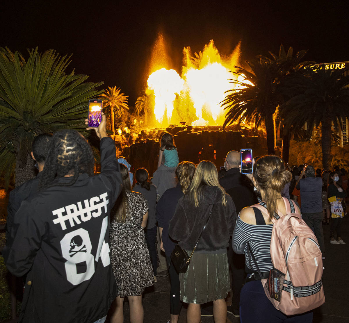A large crowd gather to watch the volcano at The Mirage on the Strip, on Friday, March, 19, 202 ...