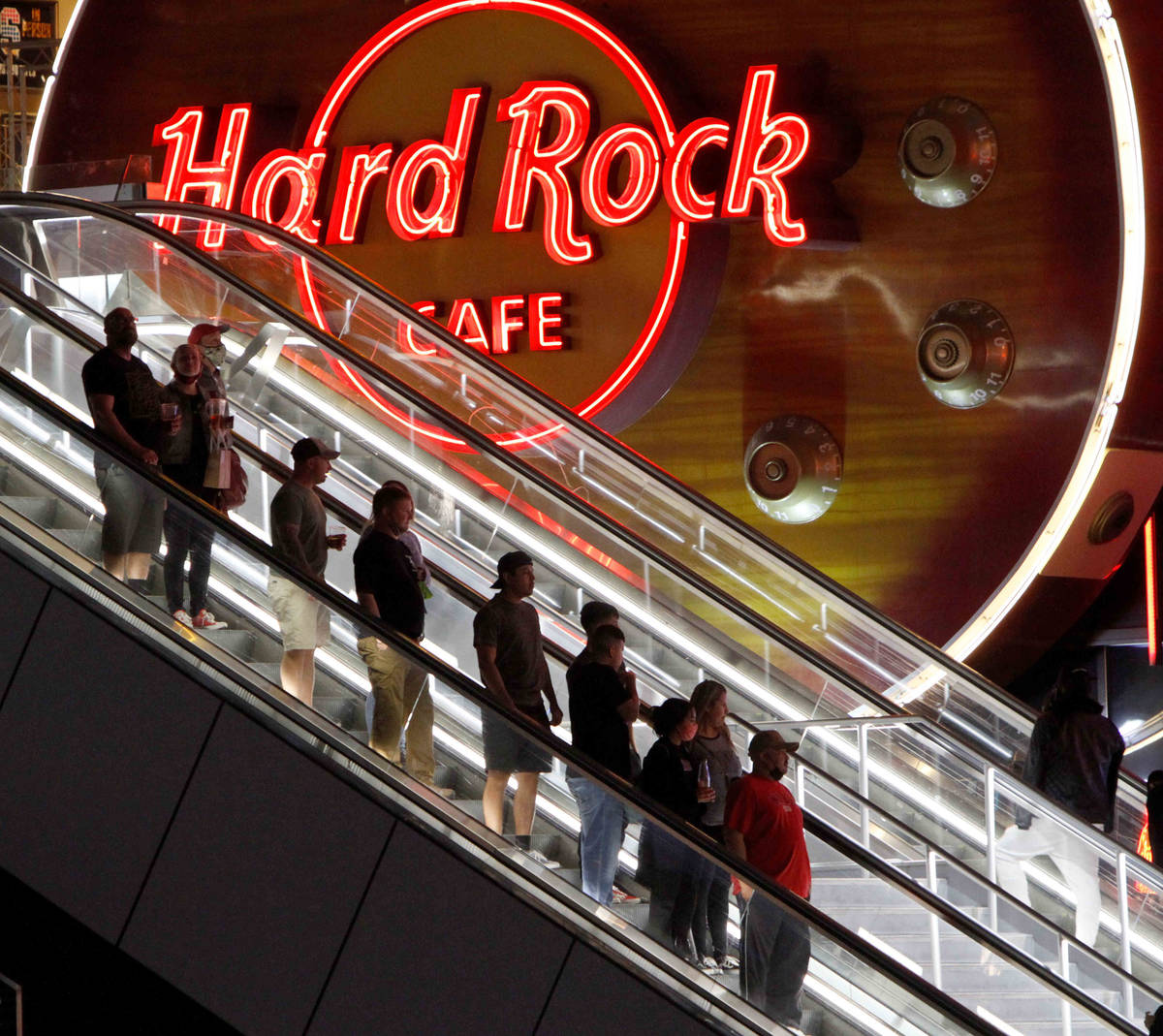 People ride escalators next to Hard Rock Cafe on the Las Vegas Strip, Friday, March 19, 2021. ( ...