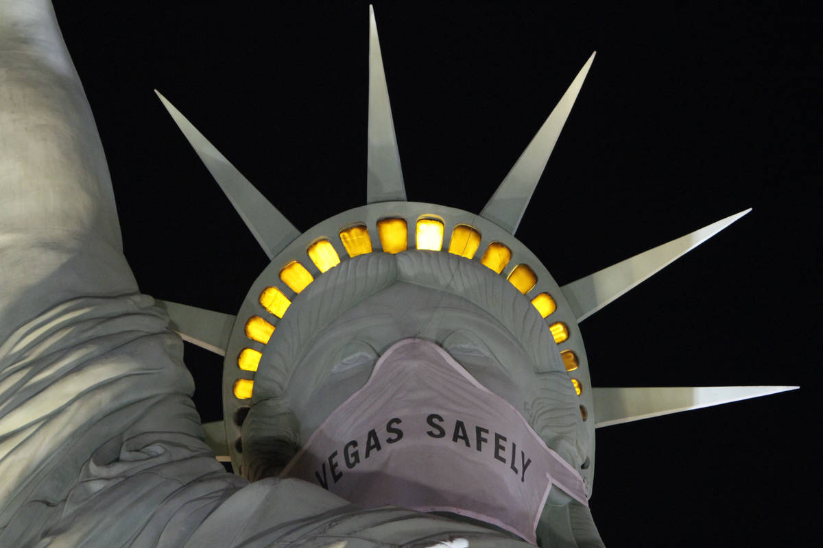 Statue of Liberty wears a mask at New York-New York in Las Vegas, Friday, March 19, 2021. (Chit ...