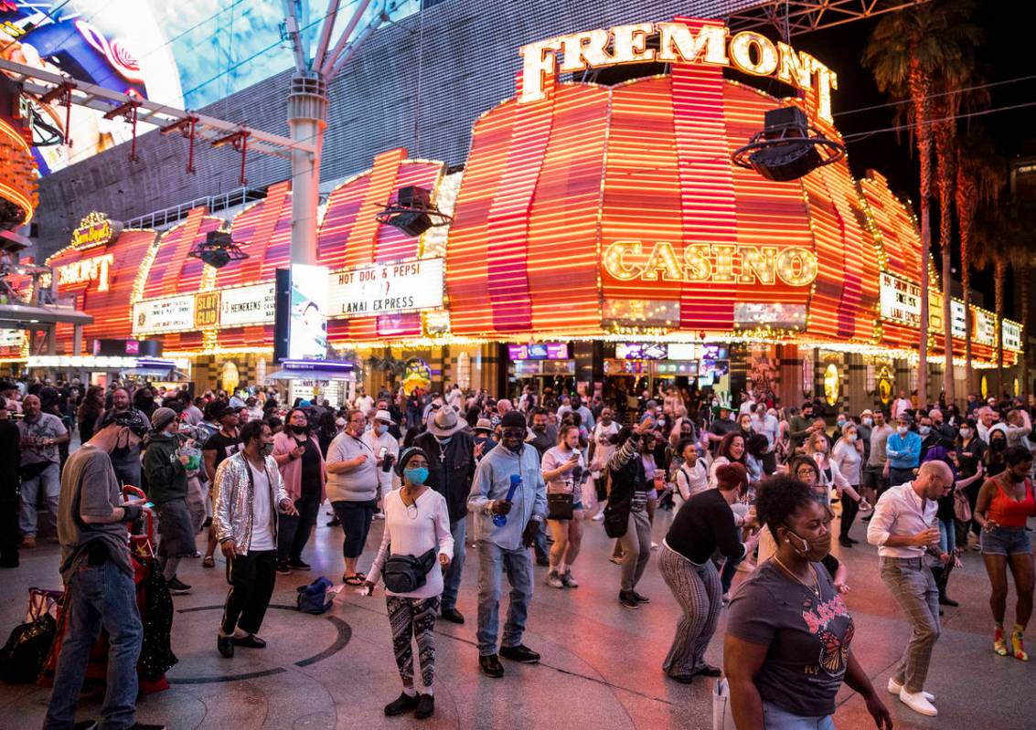 People visit the Fremont Street Experience in Las Vegas, Friday, March 19, 2021. (Erik Verduzco ...