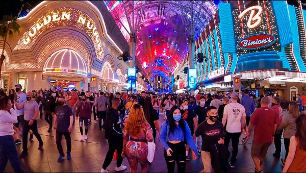 In this frame grab from video people walk along Fremont Street Experience in Las Vegas, Friday, ...