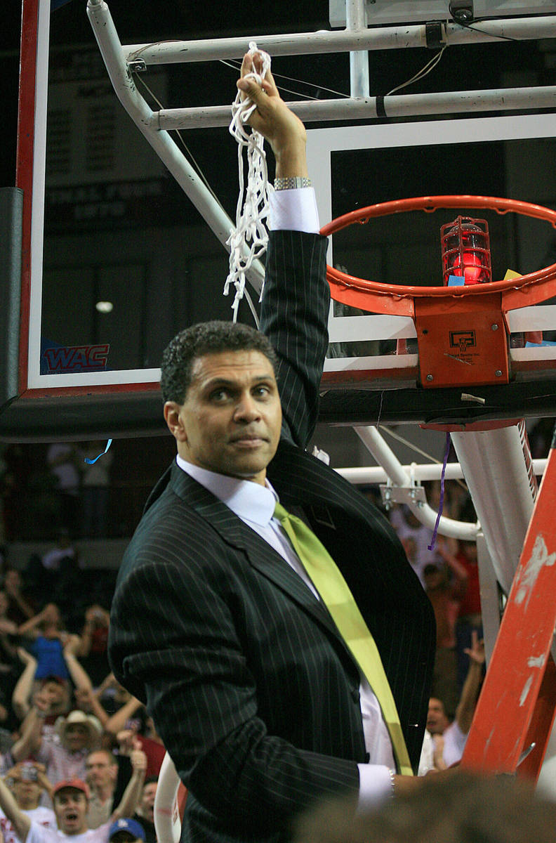 New Mexico State coach Reggie Theus cuts down the net after his team defeated Utah State 72-70 ...
