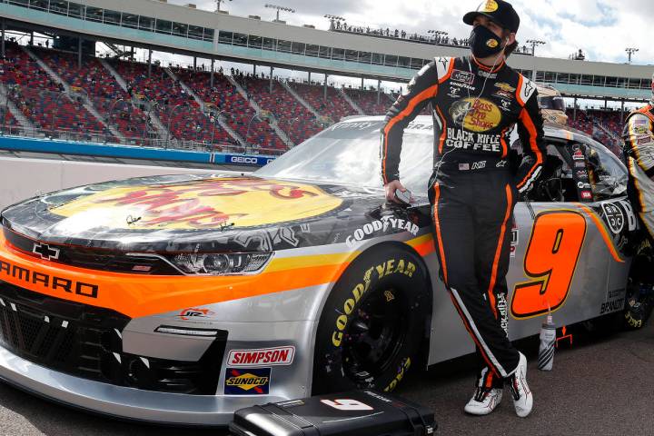 Noah Gragson, left, stands with his race car on pit road prior to a NASCAR Xfinity Series auto ...