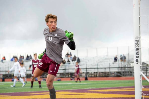Faith Lutheran goalkeeper Landon Amick (0) looks to see that his block of a Bishop Gorman point ...