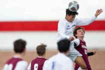 Bishop Gorman defender George Charles (15), left, heads the ball as Faith Lutheran forward Jere ...