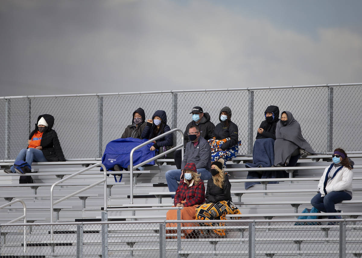Bishop Gorman fans are dressed for cold weather while watching the boys varsity high school soc ...