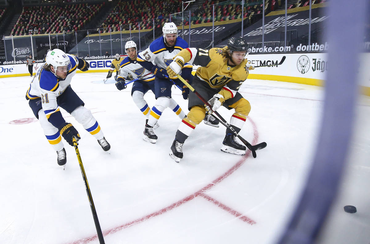 Golden Knights' William Karlsson (71) controls the puck under pressure from St. Louis Blues' Ky ...