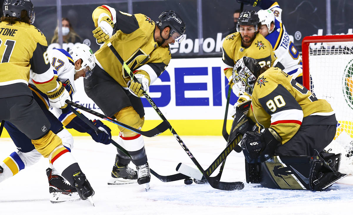 St. Louis Blues' Jaden Schwartz (17) battles for the puck against Golden Knights' Brayden McNab ...