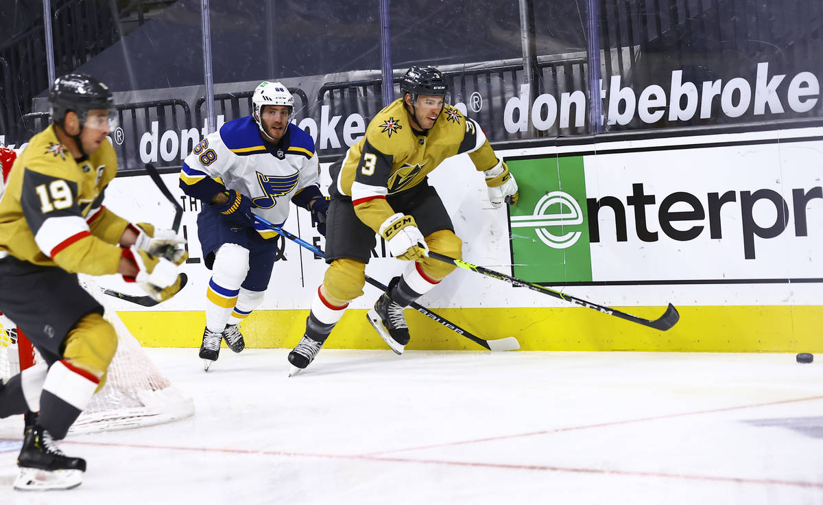 Golden Knights' Brayden McNabb (3) goes after the puck in front of St. Louis Blues' Mike Hoffma ...