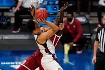 Gonzaga guard Jalen Suggs (1) charges into Oklahoma forward Kur Kuath (52) in the first half of ...