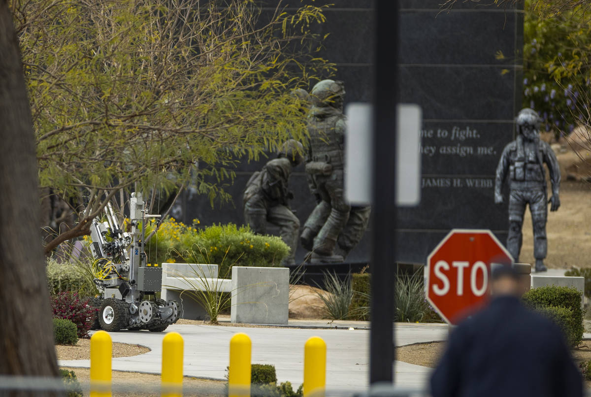 A bomb squad robot rolls into place to check out a suspicious item on the ground at the Nevada ...