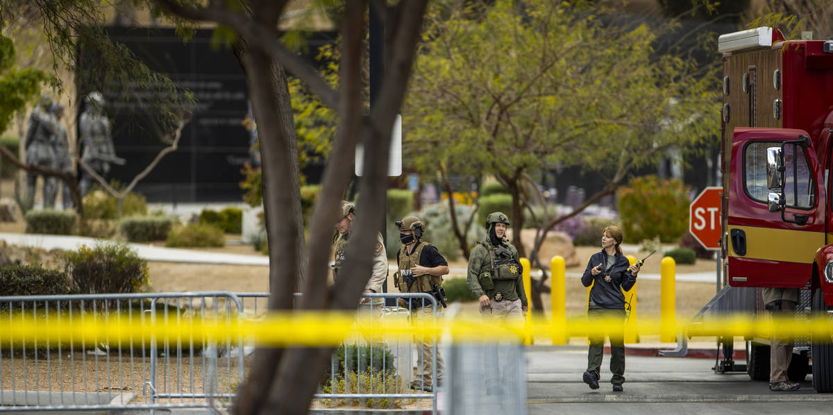 Bomb squad personnel work at the scene as a suspicious item on the ground is investigated at th ...