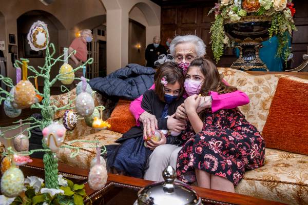 Ellie Levi, 90, center, hugs her great-granddaughters Emery Cuthbert, 6, left, and Hailey Cuthb ...