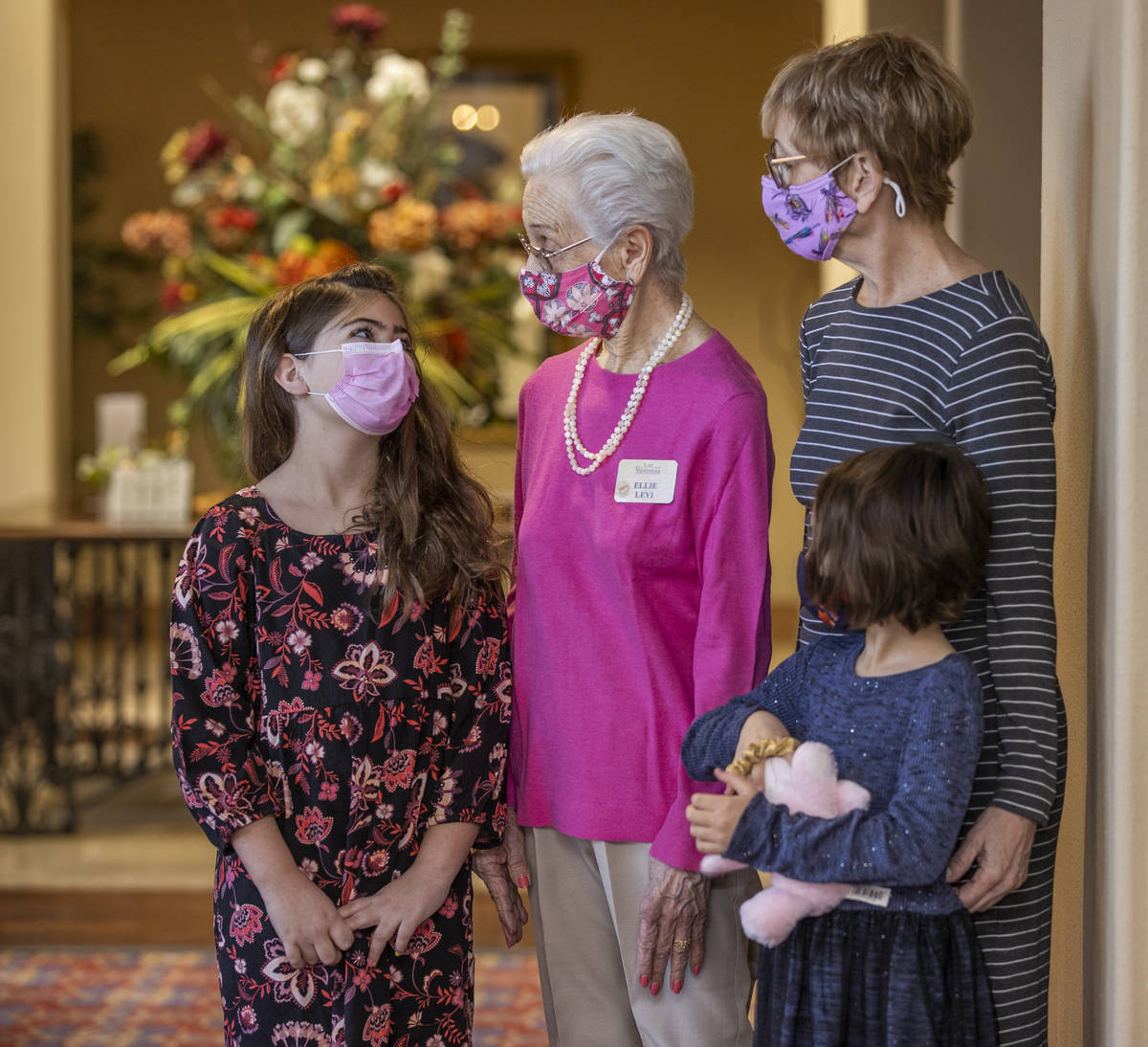 Hailey Cuthbert, 9, left, looks to her great grandmother Ellie Levi, 90, center, with her siste ...