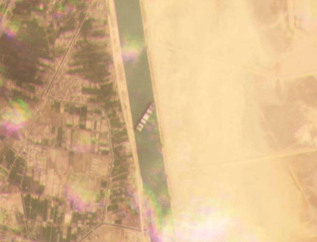 This satellite image from Planet Labs Inc. shows the cargo ship MV Ever Given stuck in the Suez ...
