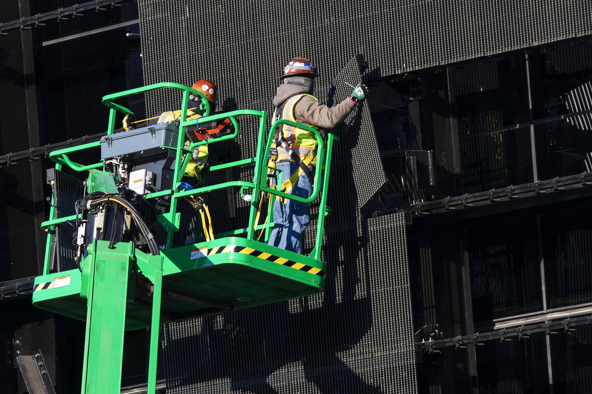 Workers removing video panels on Allegiant Stadium, on Wednesday, March 24, 2021, in Las Vegas. ...